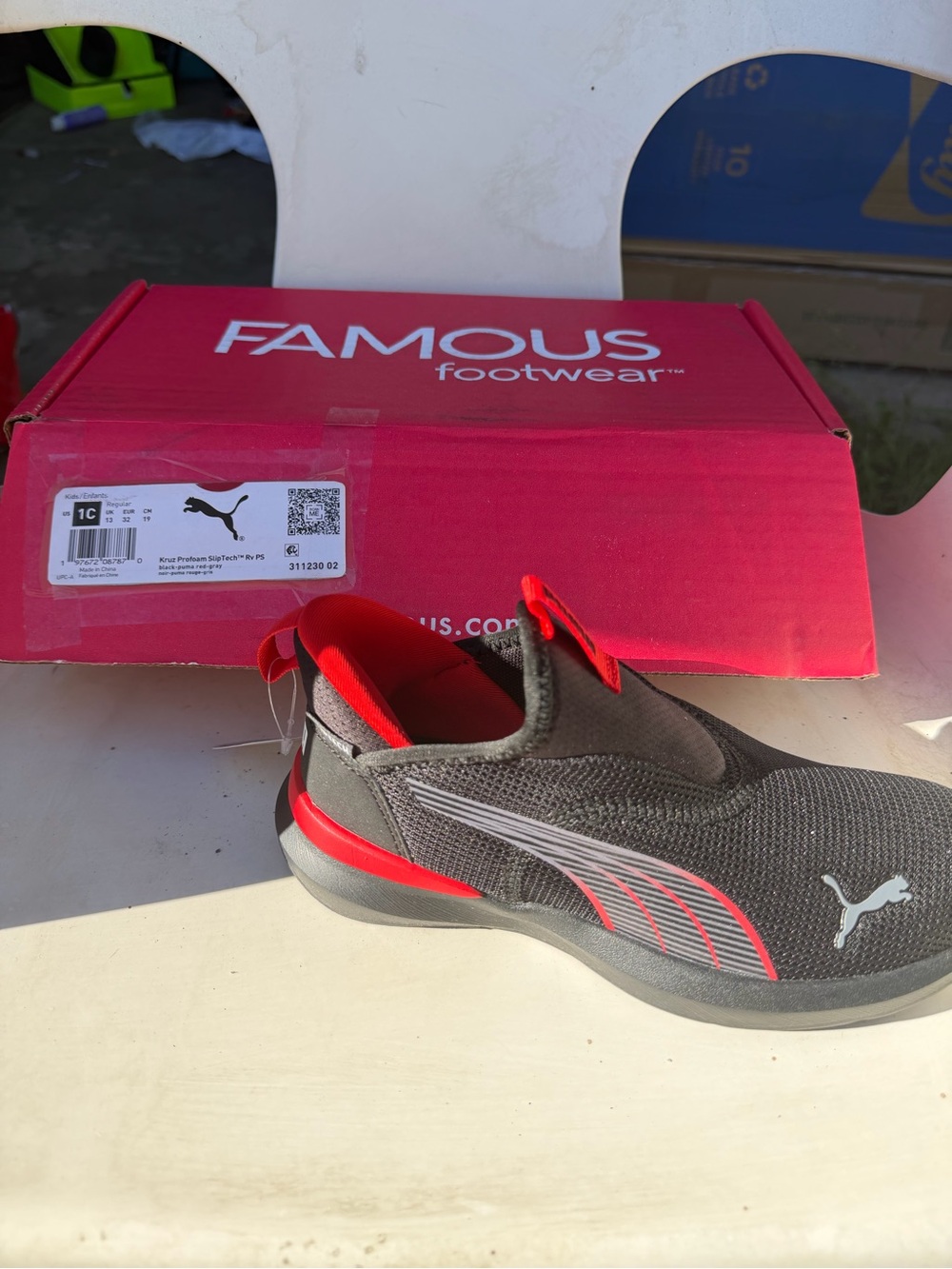 Brand New. Puma Kids Black Slip-On with Red Accents. 1C